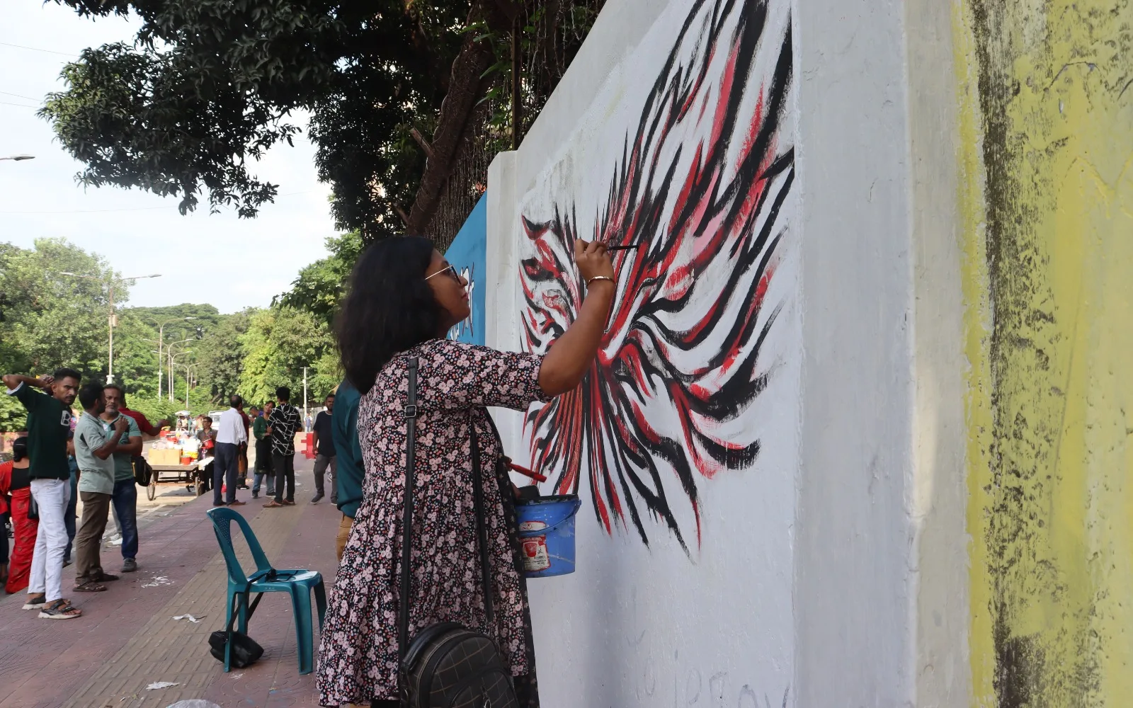 Students and artists restoring graffiti created during and after the July mass uprising at Dhaka University.