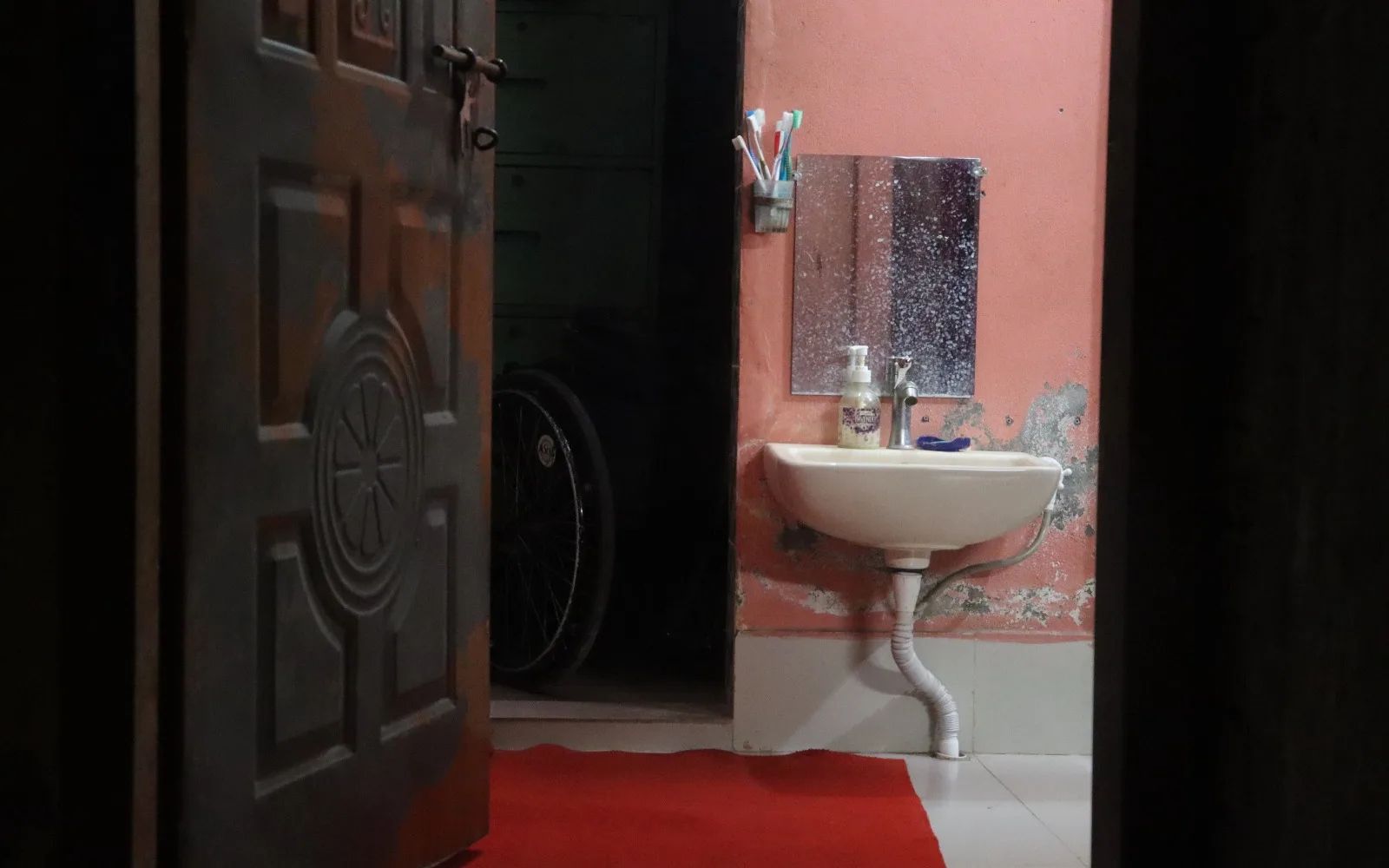 The washbasin was lower than usual, positioned at a height that allowed someone sitting in a chair to use it comfortably.
