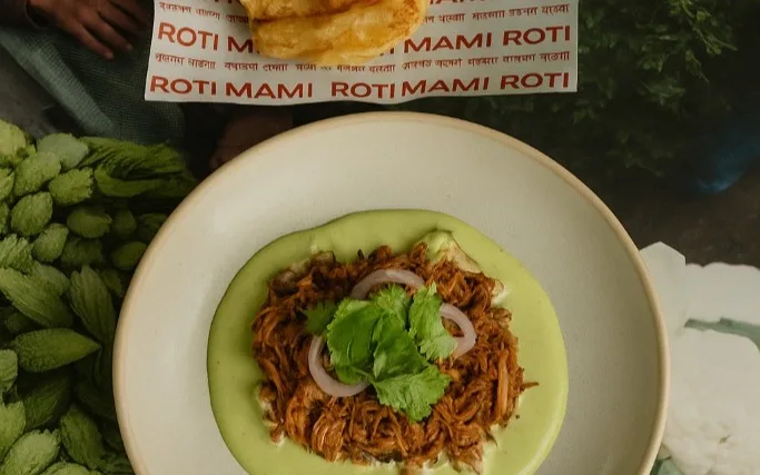 Rez Rahman's Sylheti duck ‘tacos’ of slow-cooked, shredded duck kosha folded through achar spices, served on flaky lachha paratha with burnt orange and fresh herbs.