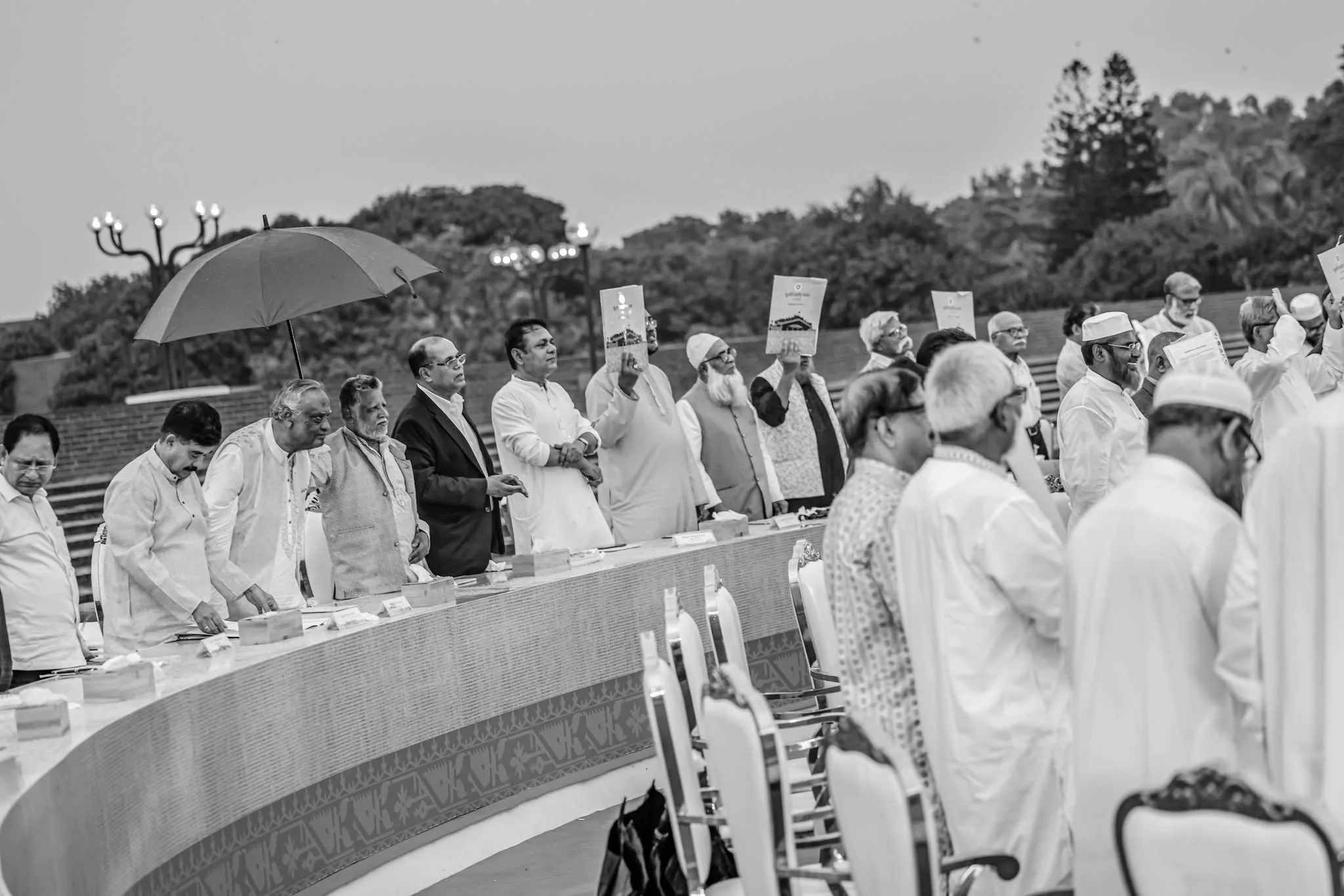 Political leaders hold copies of the July National Charter as they stand after signing the document at the South Plaza of the National Parliament in Dhaka on 17 October 2025.